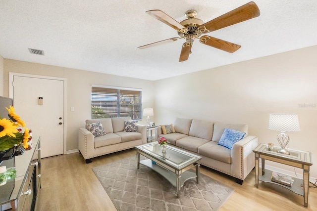 living room with hardwood / wood-style flooring and a textured ceiling