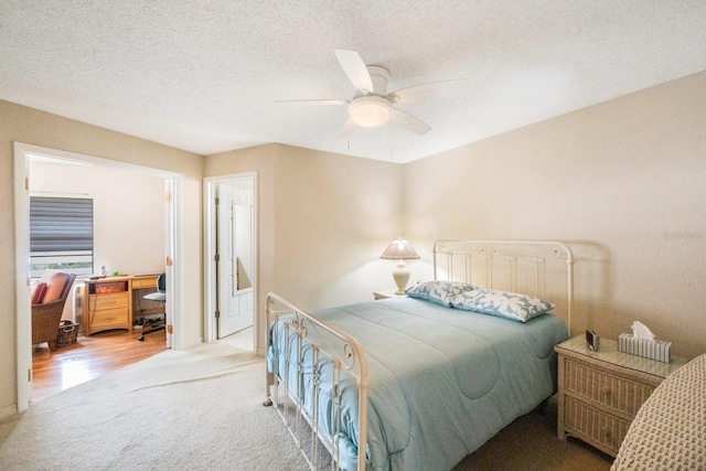 carpeted bedroom featuring a textured ceiling and ceiling fan