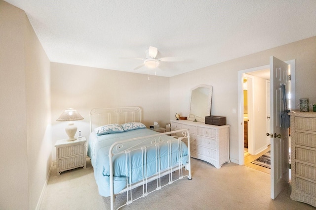 carpeted bedroom with connected bathroom and ceiling fan