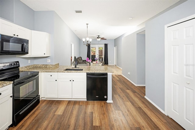 kitchen featuring black appliances, decorative light fixtures, white cabinetry, sink, and kitchen peninsula