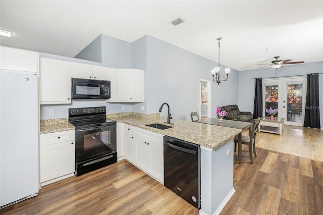 kitchen with sink, white cabinets, black appliances, and french doors