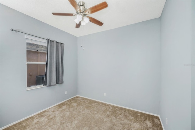 carpeted empty room featuring ceiling fan