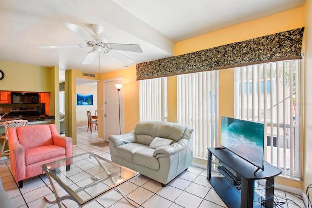 tiled living room with ceiling fan