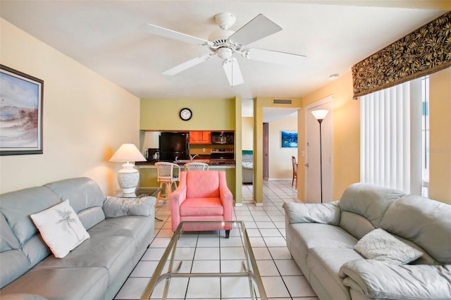 tiled living room featuring ceiling fan