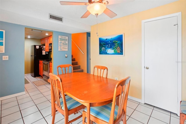 tiled dining area featuring ceiling fan