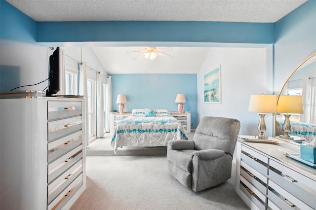 carpeted bedroom featuring ceiling fan, a textured ceiling, and vaulted ceiling