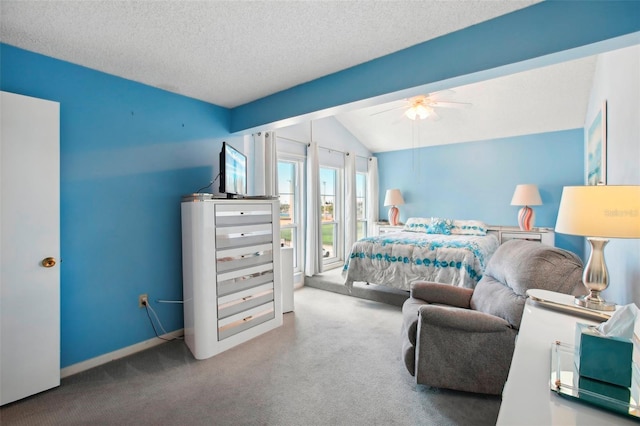 bedroom with ceiling fan, vaulted ceiling, a textured ceiling, and carpet flooring