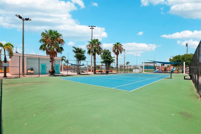 view of tennis court with basketball hoop