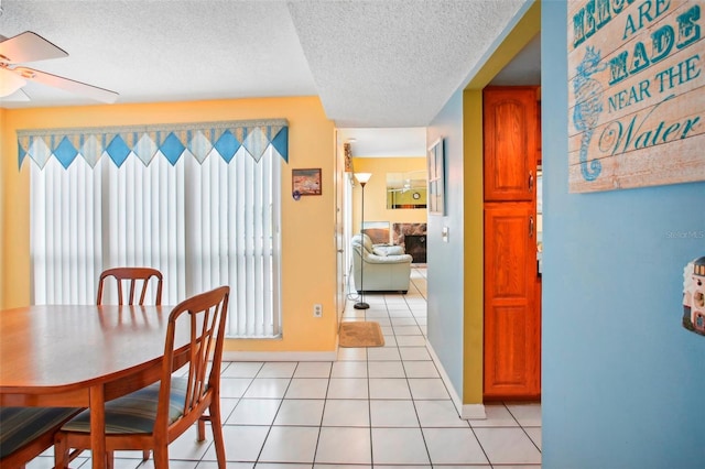343 Rex Pl Unit F, Madeira Beach, FL 33708 - dining space with plenty of natural light, ceiling fan, a textured ceiling, and light tile patterned flooring