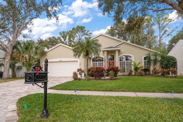 ranch-style house with a front yard and a garage