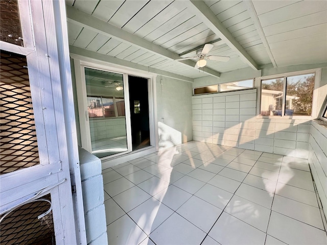 unfurnished sunroom with ceiling fan, wood ceiling, and beam ceiling