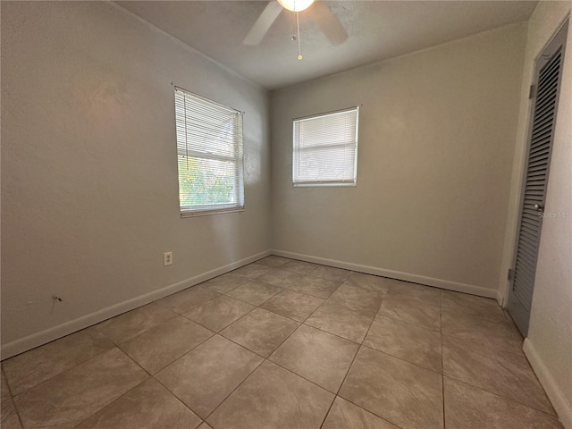 unfurnished bedroom featuring ceiling fan, a closet, and light tile patterned flooring