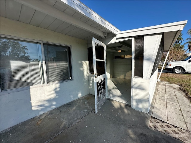 view of exterior entry featuring a patio