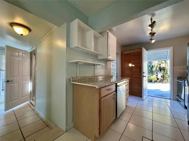 kitchen featuring light tile patterned floors, appliances with stainless steel finishes, light brown cabinetry, and light stone countertops