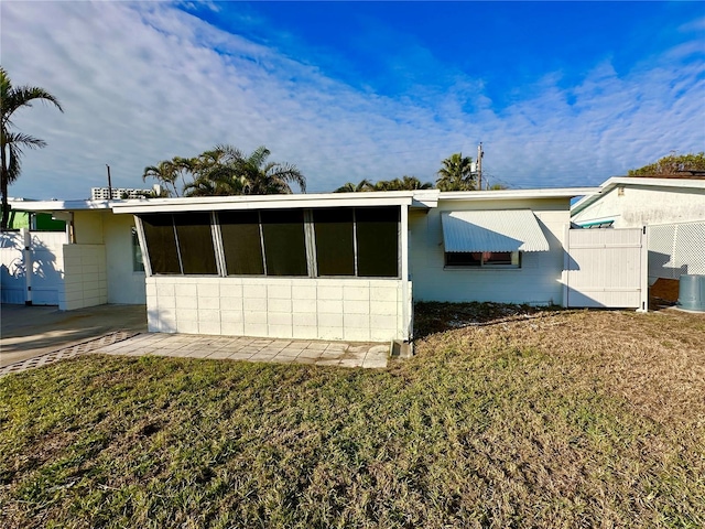 view of side of home with a yard