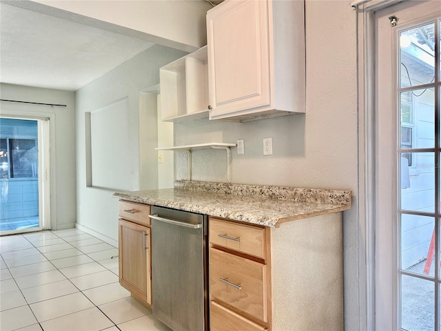 kitchen featuring light tile patterned flooring, light brown cabinetry, and light stone countertops