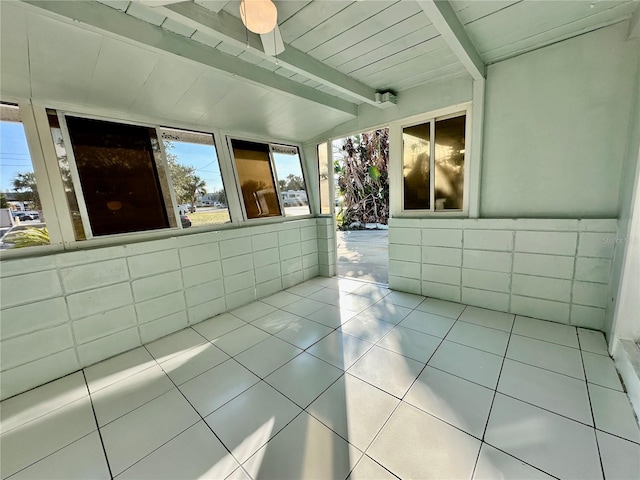 interior space with ceiling fan, wood ceiling, and beamed ceiling