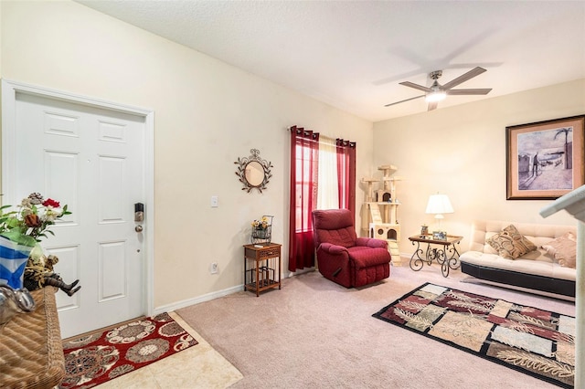 carpeted living room featuring ceiling fan