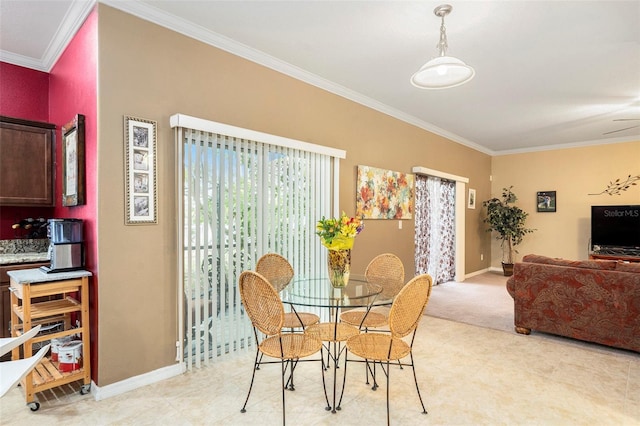 carpeted dining space featuring ceiling fan and ornamental molding