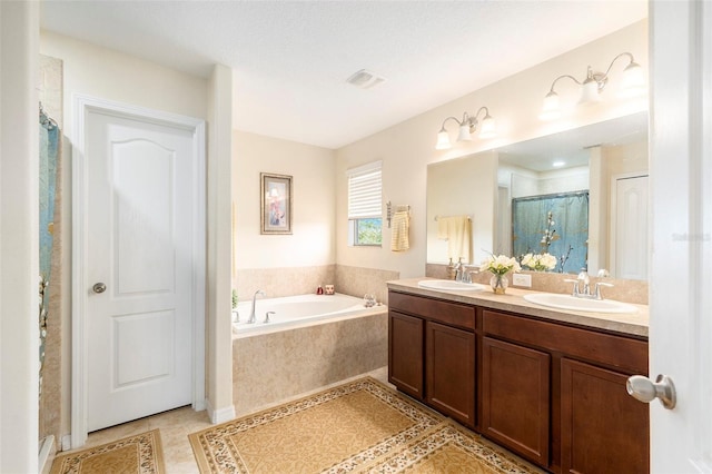 bathroom featuring vanity, tile patterned flooring, and separate shower and tub