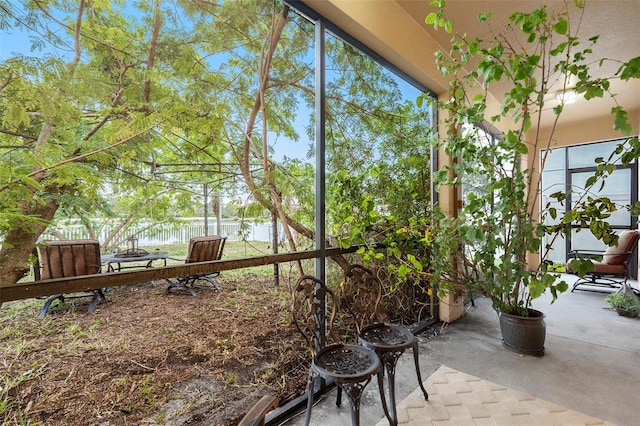 unfurnished sunroom with a water view