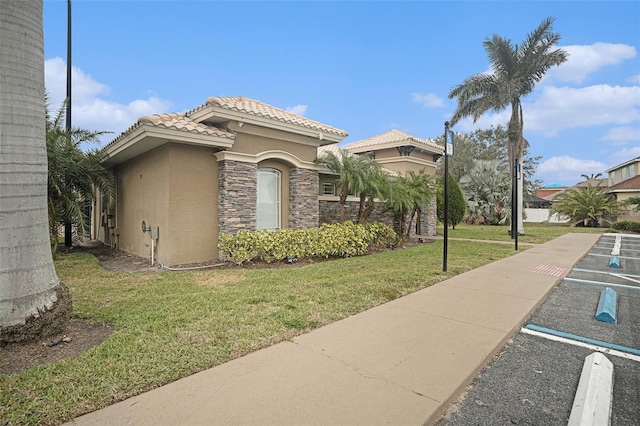 view of side of home featuring a lawn