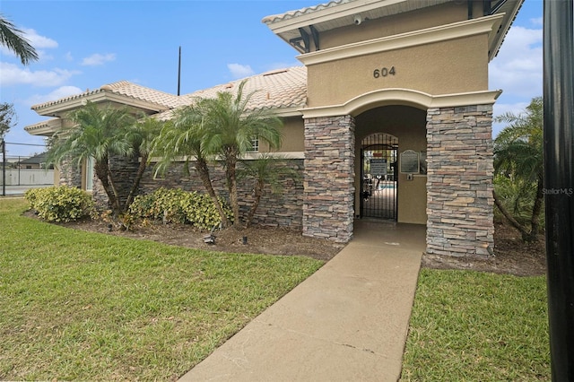 doorway to property featuring a yard