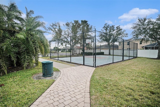 view of sport court featuring a lawn