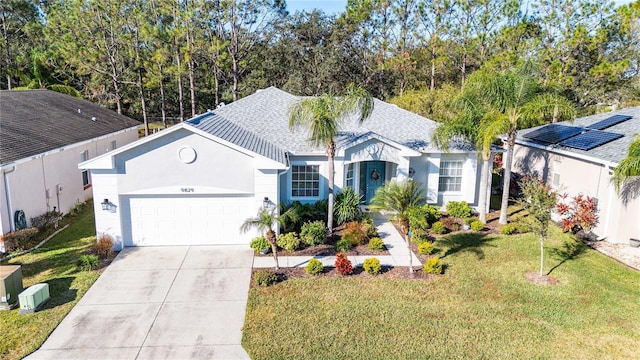 view of front of property with a front lawn and a garage