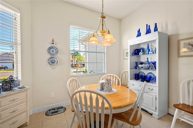 tiled dining room featuring a notable chandelier