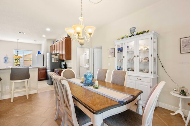 dining space with an inviting chandelier and light tile patterned floors