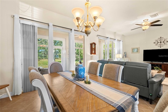 dining area with ceiling fan with notable chandelier and light tile patterned floors