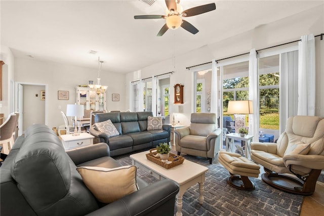 living room featuring plenty of natural light and ceiling fan with notable chandelier