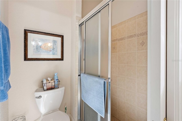 bathroom with an enclosed shower and toilet