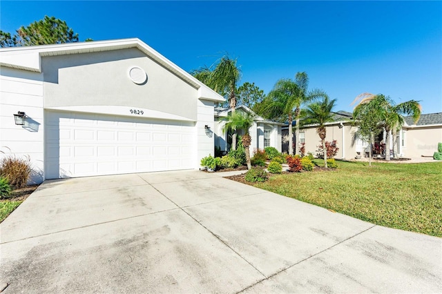 ranch-style home featuring a garage and a front yard