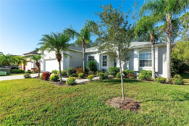 ranch-style home featuring a garage and a front yard