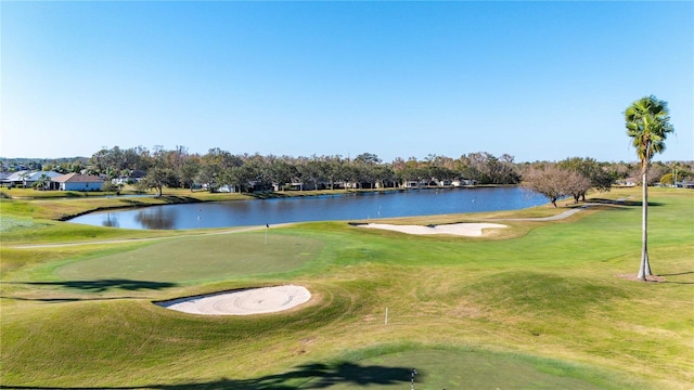 surrounding community with a yard and a water view