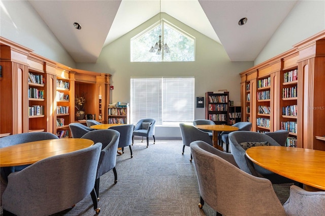 carpeted dining room featuring a healthy amount of sunlight and high vaulted ceiling