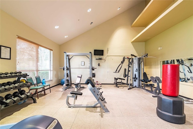 workout area featuring high vaulted ceiling