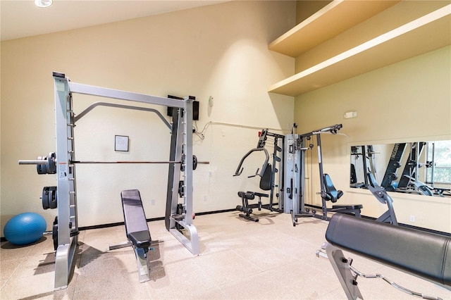 exercise room with vaulted ceiling