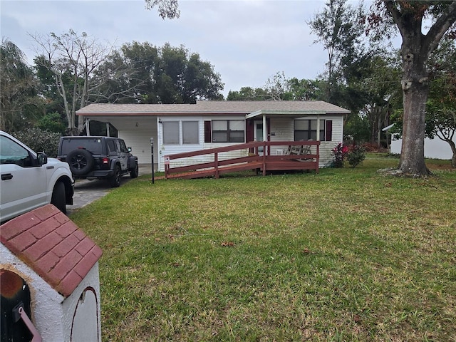 view of front of property with a front lawn and a carport