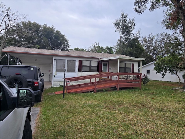 view of front facade with a front lawn and a carport