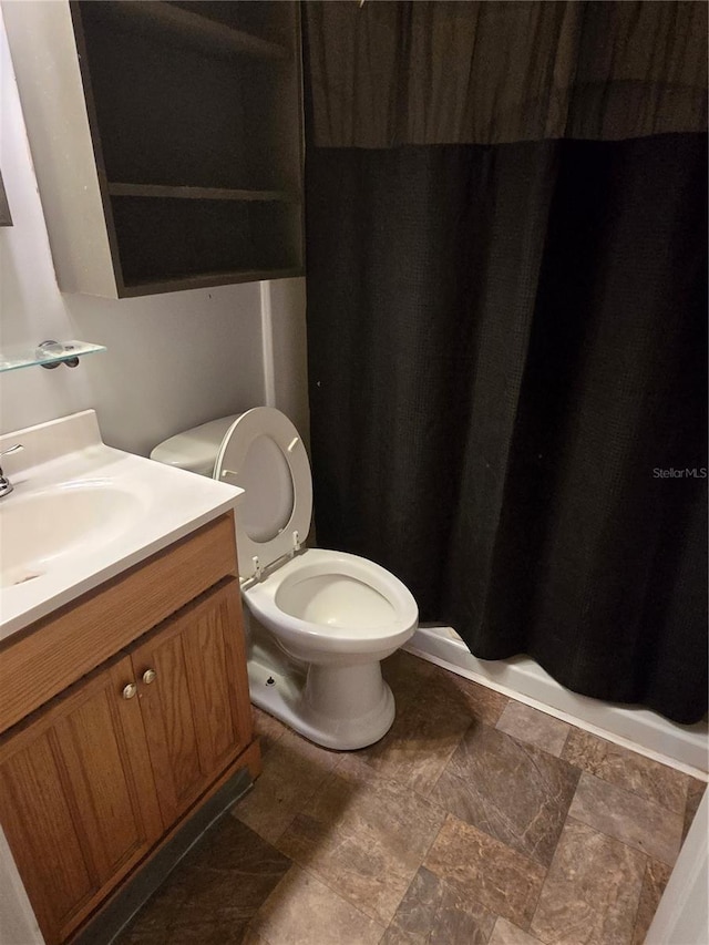 bathroom with toilet and vanity