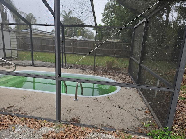 view of swimming pool with a storage unit