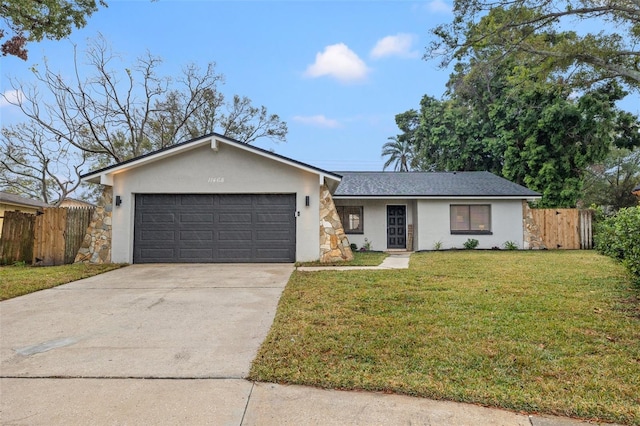 single story home featuring a garage and a front lawn