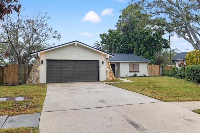 ranch-style home featuring a garage and a front yard