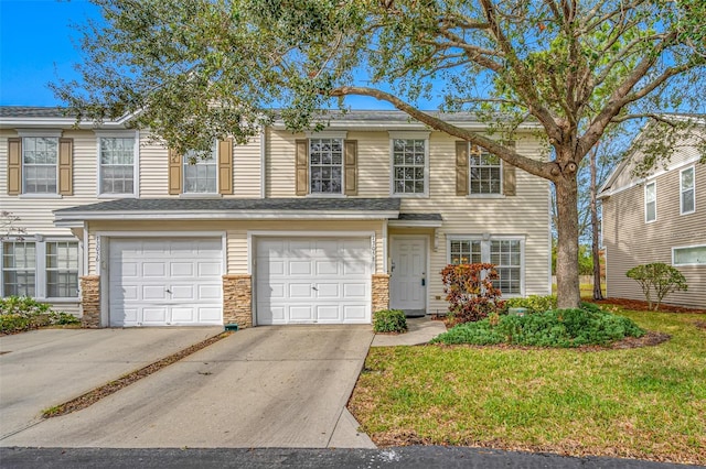 view of front of property with a front yard and a garage