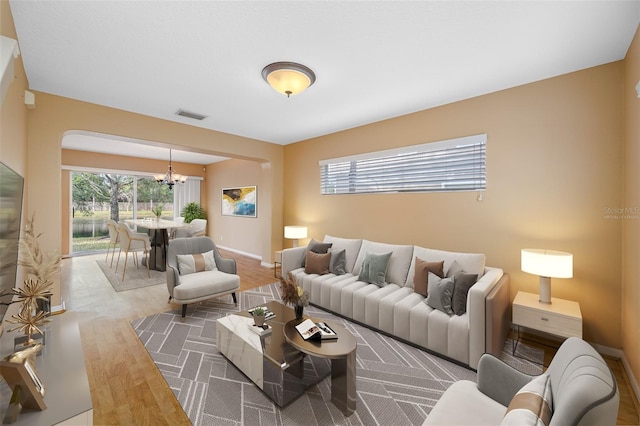 living room featuring an inviting chandelier and hardwood / wood-style flooring