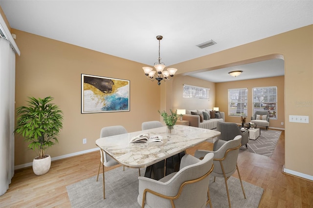 dining room featuring a chandelier and light hardwood / wood-style floors