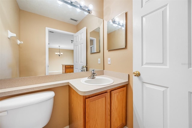 bathroom with toilet and vanity